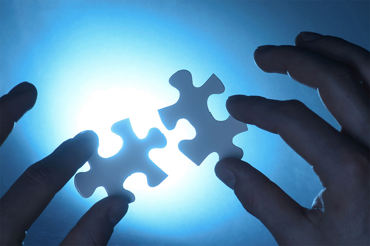 isolate hands holding puzzle pieces