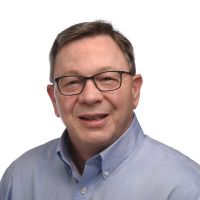 headshot of executive coach Patrick Conlon smiling at the camera on a white background